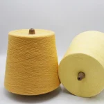 Two cones of 32/1 bamboo cotton blended yarn in light yellow for wholesale sock yarn orders