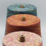 Four-color space dyed poly cotton yarn cones in three colorways for bulk textile use