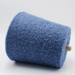 Dark blue 13s soft loop wool blend yarn cone, side angle showing loop texture