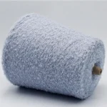 Light blue soft loop wool blend yarn cone, side view, 13s boucle texture