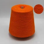 Orange viscose nylon boucle yarn cone with close-up loop texture for fashion knit fabric