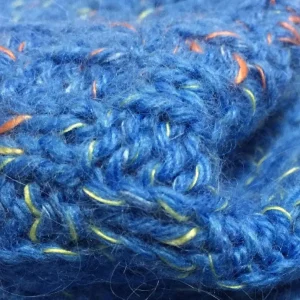 Blue fancy sock yarn close-up with decorative contrast filaments