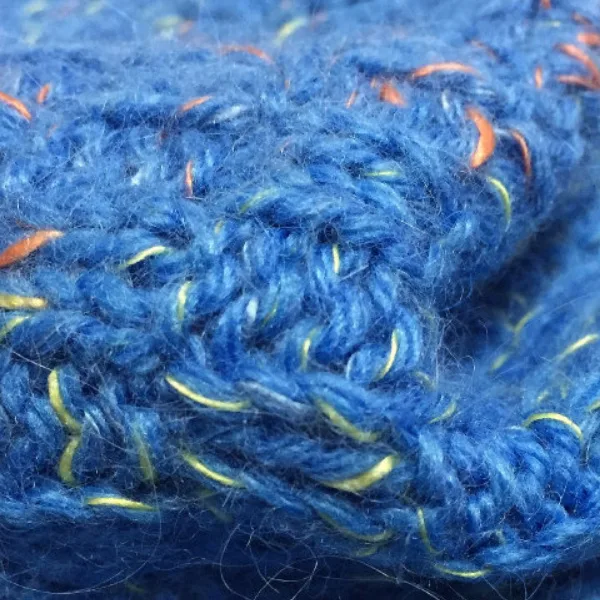 Blue fancy sock yarn close-up with decorative contrast filaments