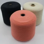 Custom color wool acrylic sock yarn cones in pink, black, and ivory