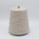Beige heat generating brushed yarn cone for soft warm socks and knitwear