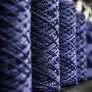 Blue quick-drying yarn cones on the VI-TEX production line for sports socks and activewear