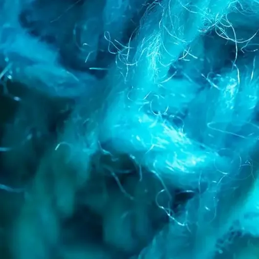 Blue colored fibers during the rubbing stage of color dot yarn production