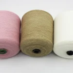 Custom color blended yarn cones in pink camel and white