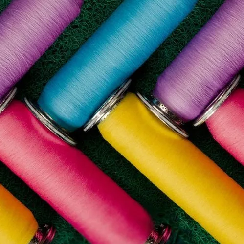 Colorful yarn cones used for functional yarn development in textile applications