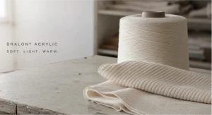 Dralon acrylic yarn cone beside soft rib-knit thermal fabric