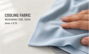 Hand touching light blue cooling fabric with a qmax threshold of 0.15