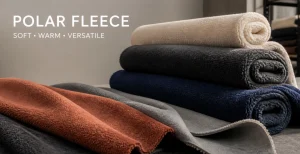 Folded polar fleece fabric rolls in ivory, black, navy and rust colours